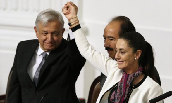 Andrés Manuel López Obrador alza el brazo de Claudia Sheinbaum.