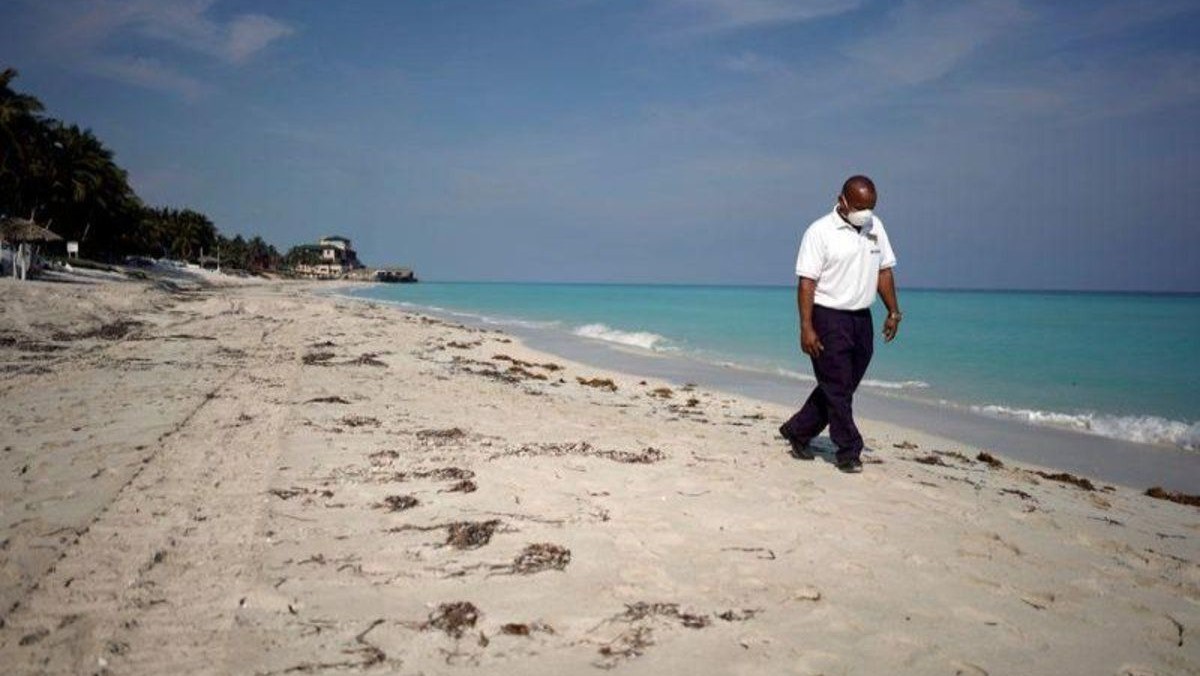 El custodio de un hotel de Varadero recorre la playa.