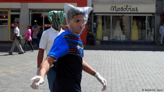 Dos hombres con bolsas como protección en Venezuela.