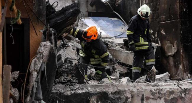 Dos bomberos buscan supervivientes en un edificio de Bordianka tras un bombardeo.